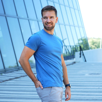 Model wearing a denim blue Giza Egyptian cotton t-shirt with a tailored fit by Intersect Collection
