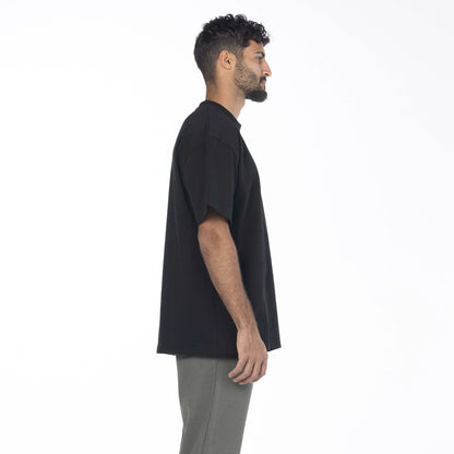 Model wearing a black Giza Egyptian cotton shirt with a drop shoulder fit by Intersect Collection